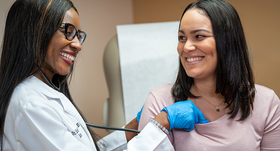 Helen-Valentine Chukwu, DO, helping patient
